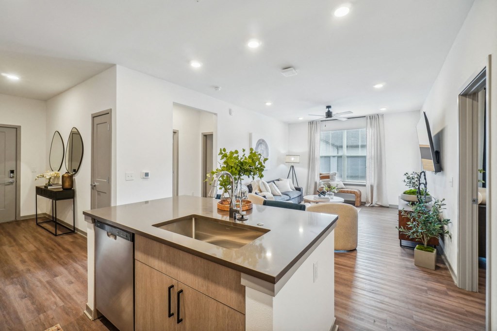 a kitchen with an island and a living room with a couch at Premier at West Park Luxury Apartment Homes, Greeley, 80634