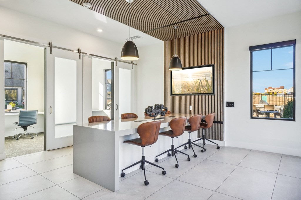 a conference room with a long desk and chairs at Premier at West Park Luxury Apartment Homes, Greeley, 80634