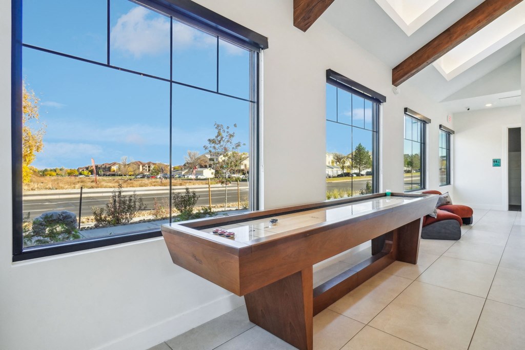 a pool table in a house with large windows at Premier at West Park Luxury Apartment Homes, Greeley, CO