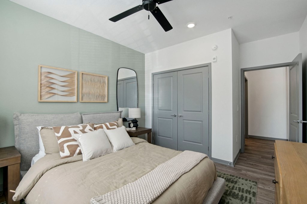 a bedroom with a large bed and a ceiling fan at The Maddox Luxury Apartment Homes, Buckeye, 85326