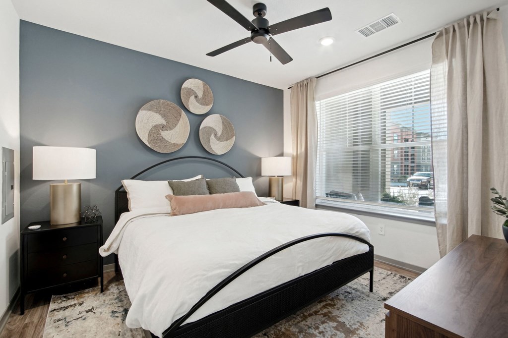 a bedroom with a bed and a ceiling fan at The Maddox Luxury Apartment Homes, Arizona