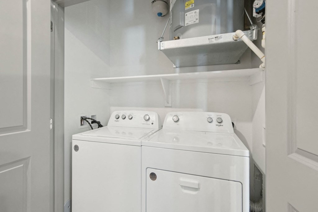 a white laundry room with two washes and a dryer at The Maddox Luxury Apartment Homes, Arizona, 85326
