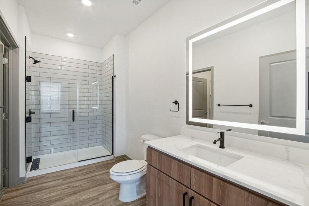 a bathroom with a sink and a toilet and a shower at The Maddox Luxury Apartment Homes, Arizona, 85326