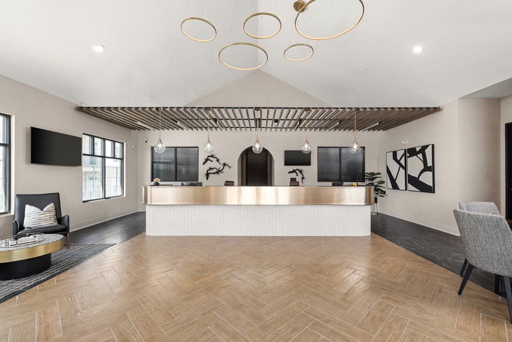 the lobby of a hotel with a reception desk and chairs