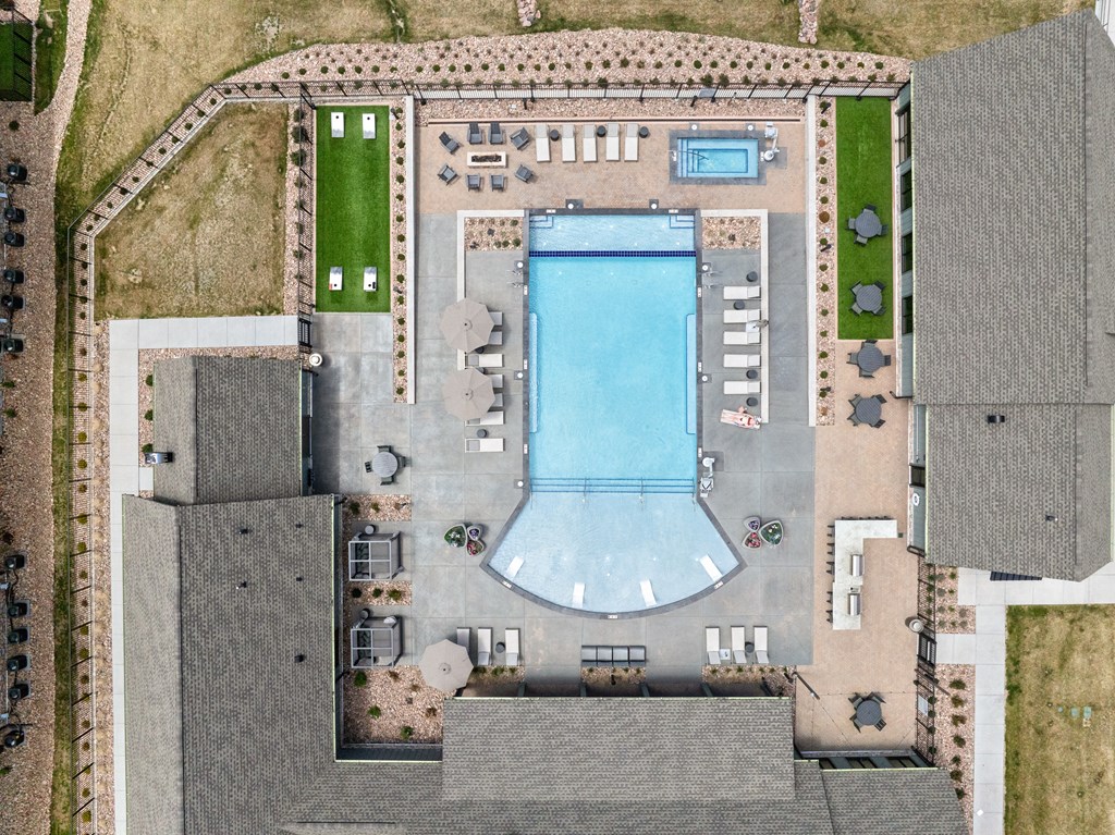 a birds eye view of a building with a pool