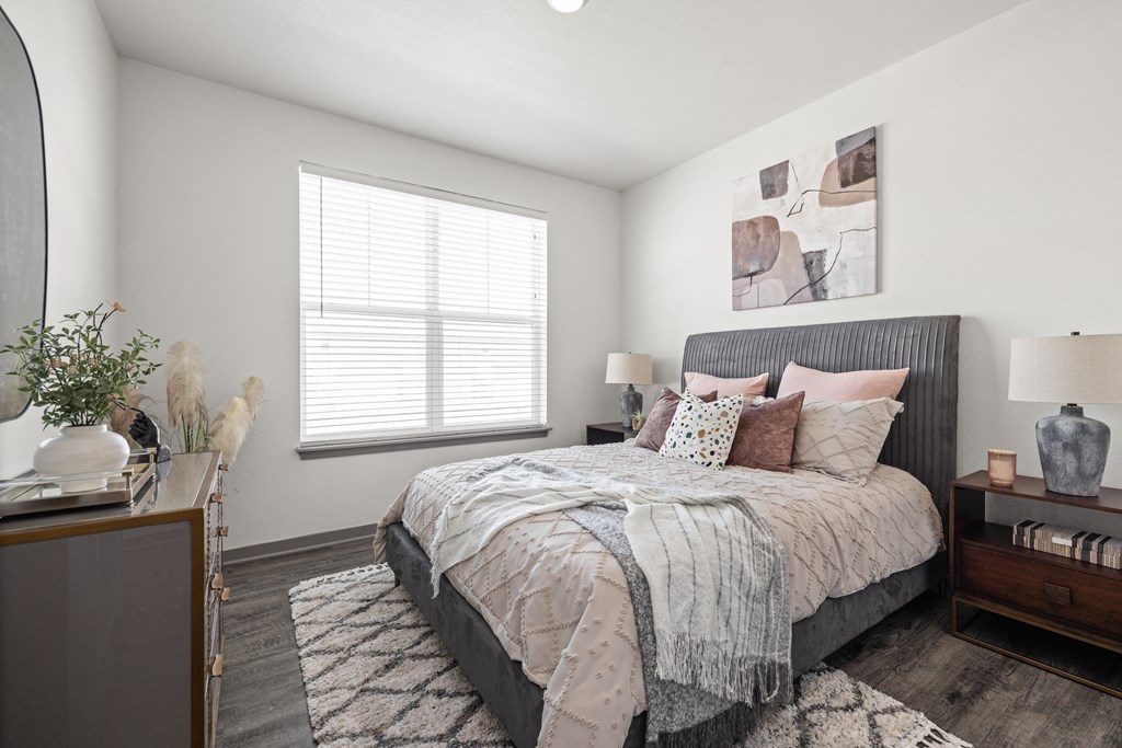 a bedroom with a large bed and a window