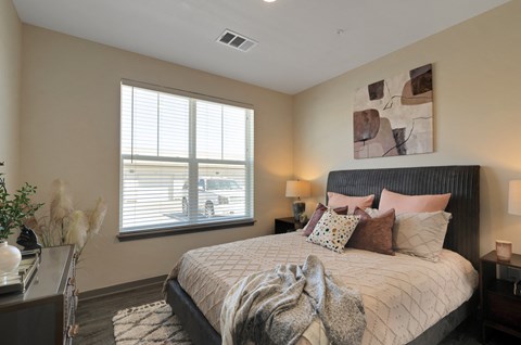 a bedroom with a large window and a large bed  at Upland Flats, Colorado Springs, Colorado
