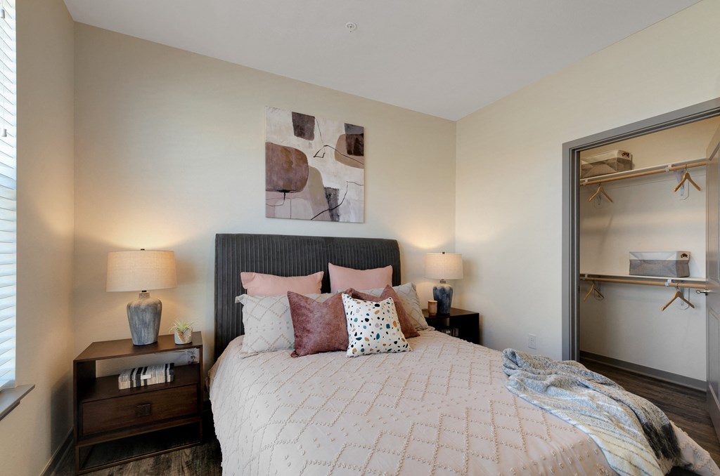 a bedroom with a large bed and two night stands with lamps  at Upland Flats, Colorado Springs