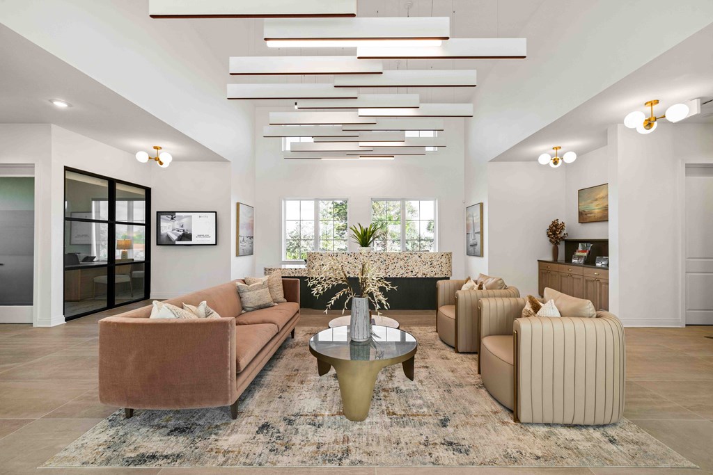 A living room with a brown sofa, a coffee table, and a rug.