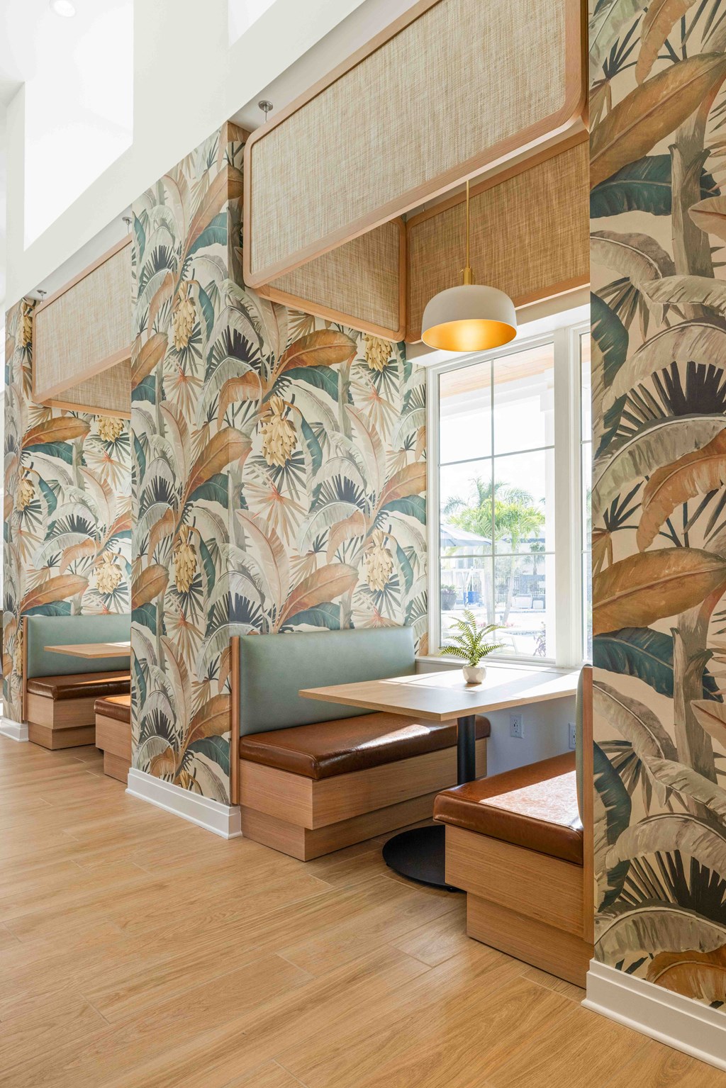 A room with a wallpapered wall and a wooden bench.