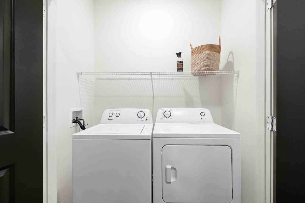A white washing machine and dryer in a small laundry room.