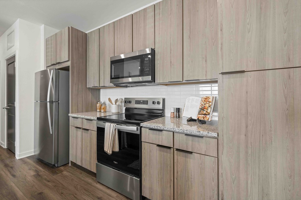 A modern kitchen with wooden cabinets and stainless steel appliances.