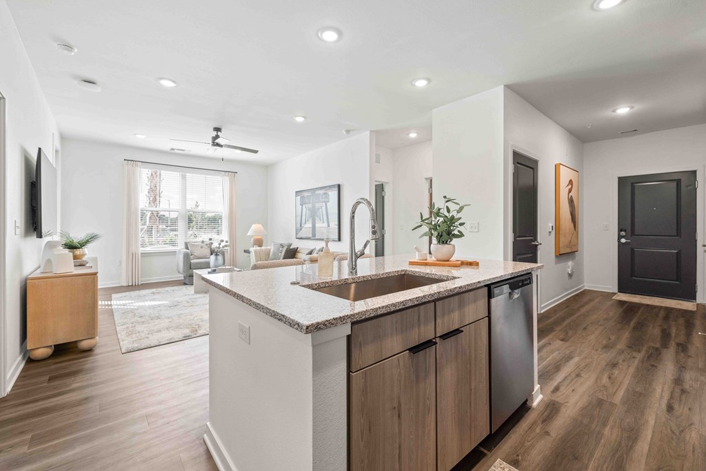 A modern kitchen with wooden cabinets and a large island.