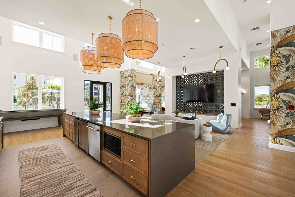 A modern kitchen with a large island and wooden floors.