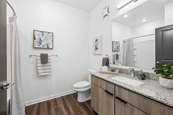 A bathroom with a white toilet and a sink.