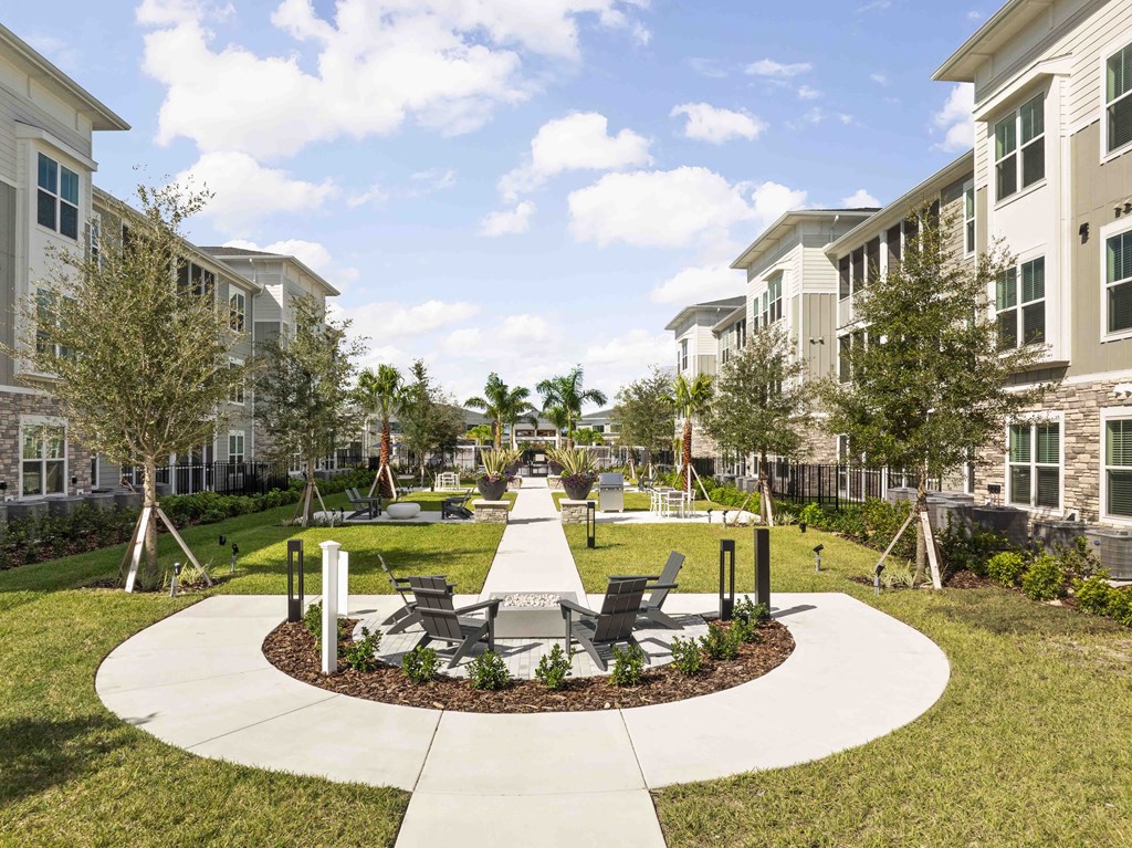 A sunny day at a residential area with apartment buildings and a park.