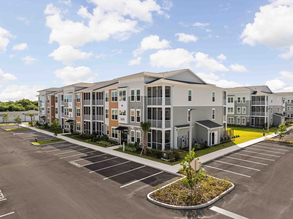 A large building with a parking lot in front of it.