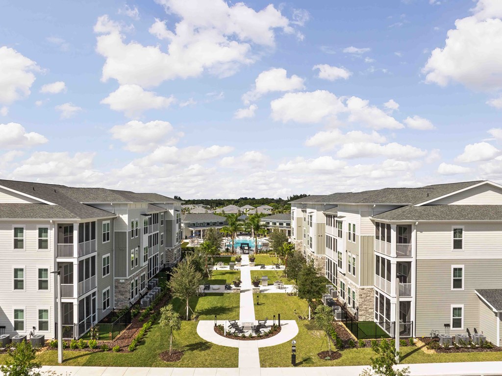 A view of a courtyard surrounded by apartment buildings.