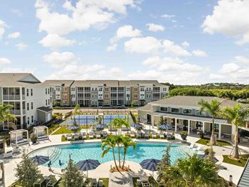 A large building with a pool in front of it.