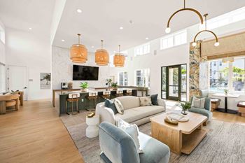 A modern living room with a bar area and a kitchen in the background.