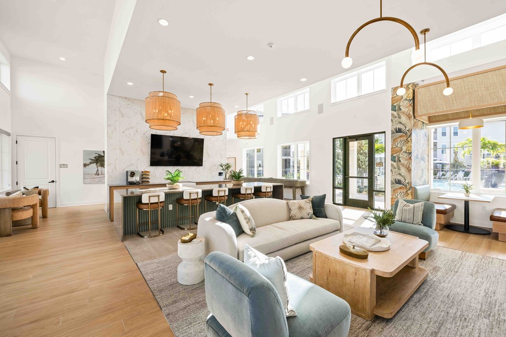 A modern living room with a bar area and a kitchen in the background.