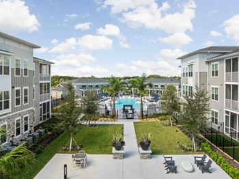 A view of a pool area with chairs and plants.