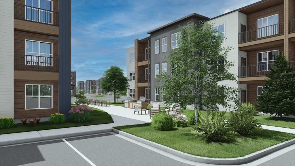 A modern apartment complex with a well-maintained garden in front at Switch Luxury Living in Colorado Springs, CO
