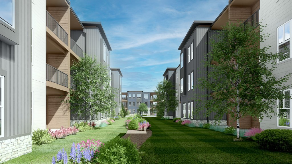 A modern apartment complex with a landscaped garden in front at Switch Luxury Living in Colorado Springs, CO