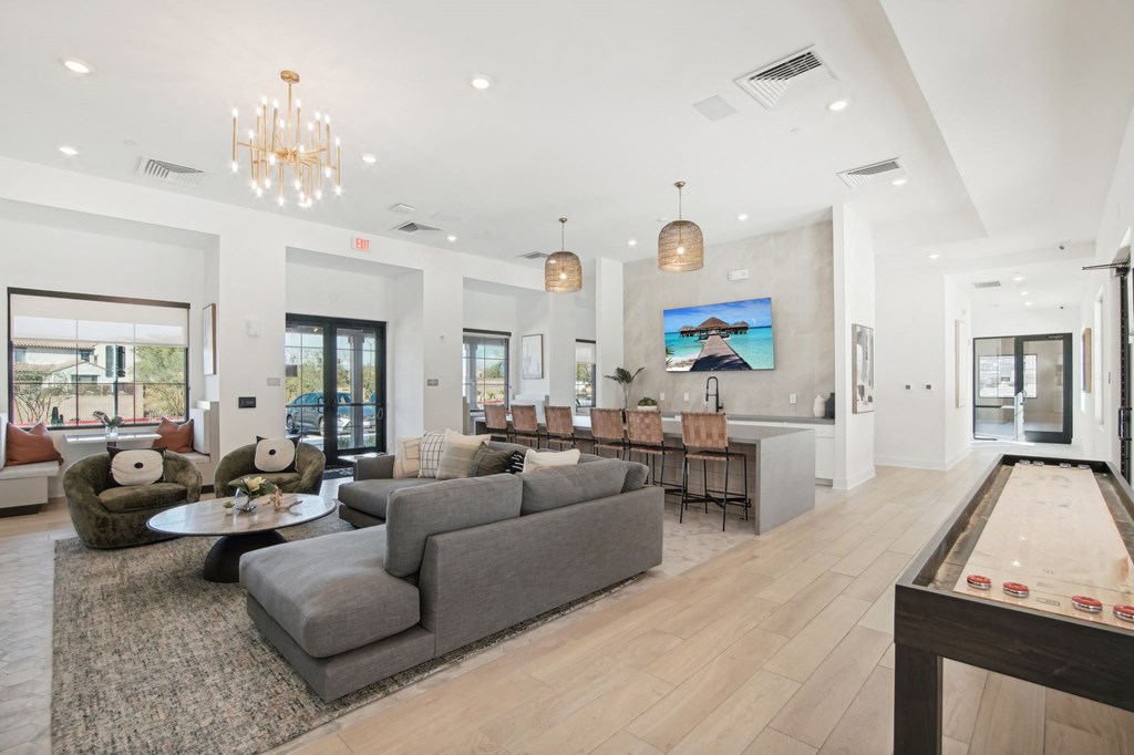 a living room with couches and chairs and a dining room table at The Maddox Luxury Apartment Homes, Arizona