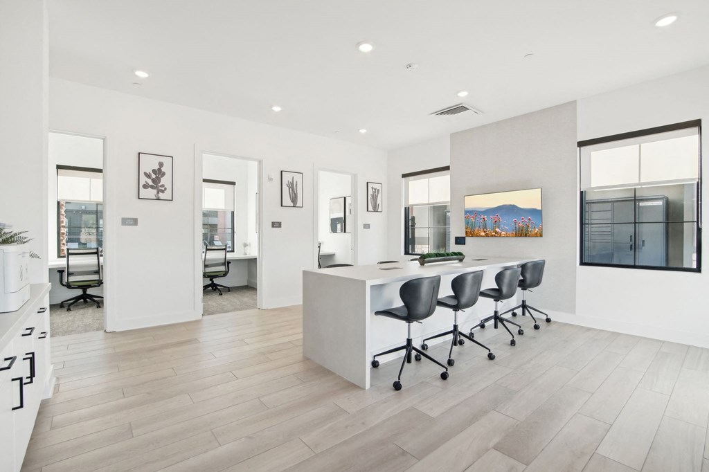 a white office with a large desk and chairs at The Maddox Luxury Apartment Homes, Buckeye, AZ 85326