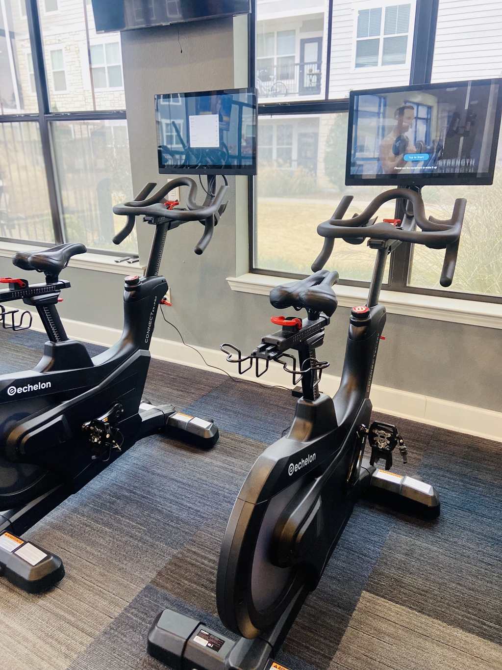 a group of exercise bikes in a gym  at Watermark at Steele Crossing, Fayetteville