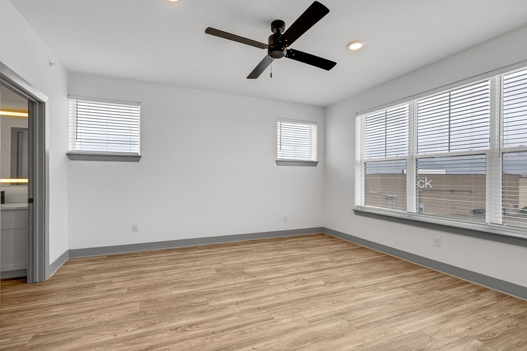 a living room with a large window and a ceiling fan at Meridian at CityPlace, Woodbury Minnesota