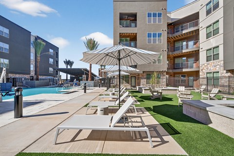 Lounge chair by pool at Refinery at Pointe17 Apartments, Phoenix