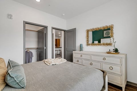a bedroom with a bed and a dresser  at Prism at Diamond Ridge, Moon Township, PA