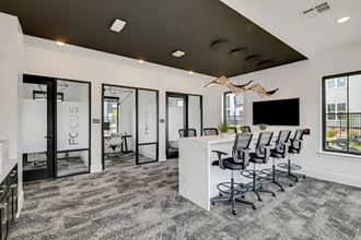 an open concept office with a white reception desk and black ceiling