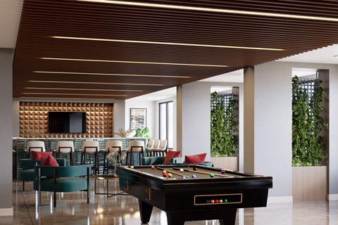 A pool table is in the middle of a room with a tv and chairs at Refinery at Pointe17 Apartments, Phoenix