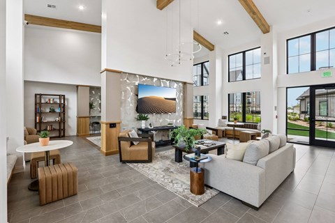 A spacious living room with a large couch, a coffee table, and a fireplace.
