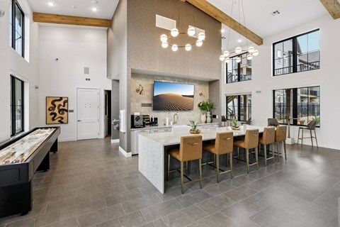 A modern kitchen with a pool table and a dining table.