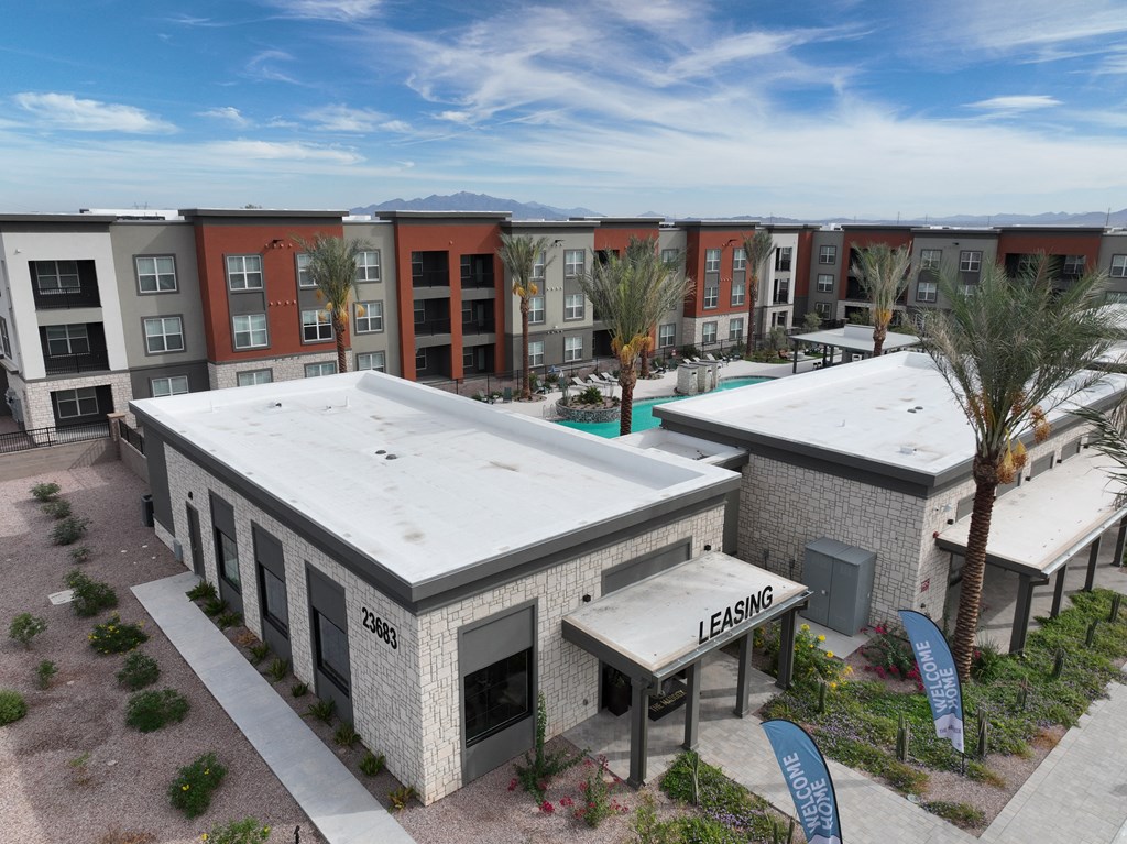 an aerial view of a building with a white roof and a pool at The Maddox Luxury Apartment Homes, Buckeye, AZ
