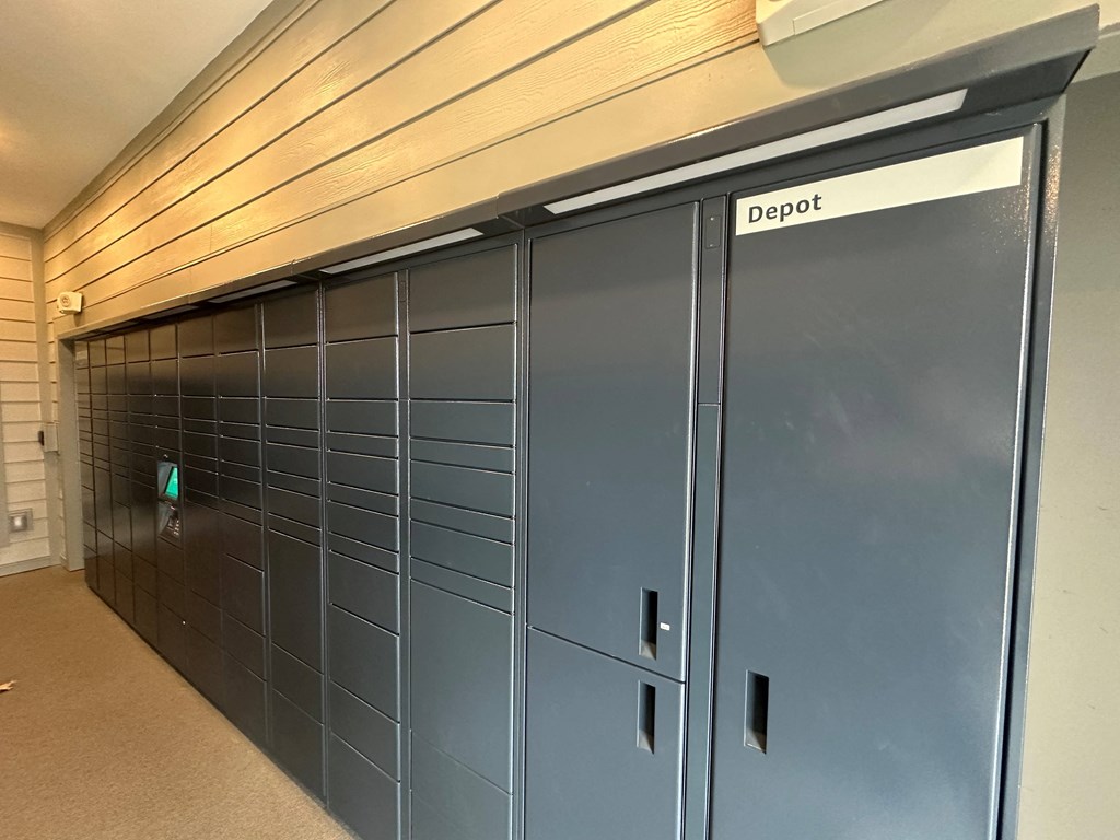 a set of blue lockers in a hallway of a building at The Depot, Raymore, 64083