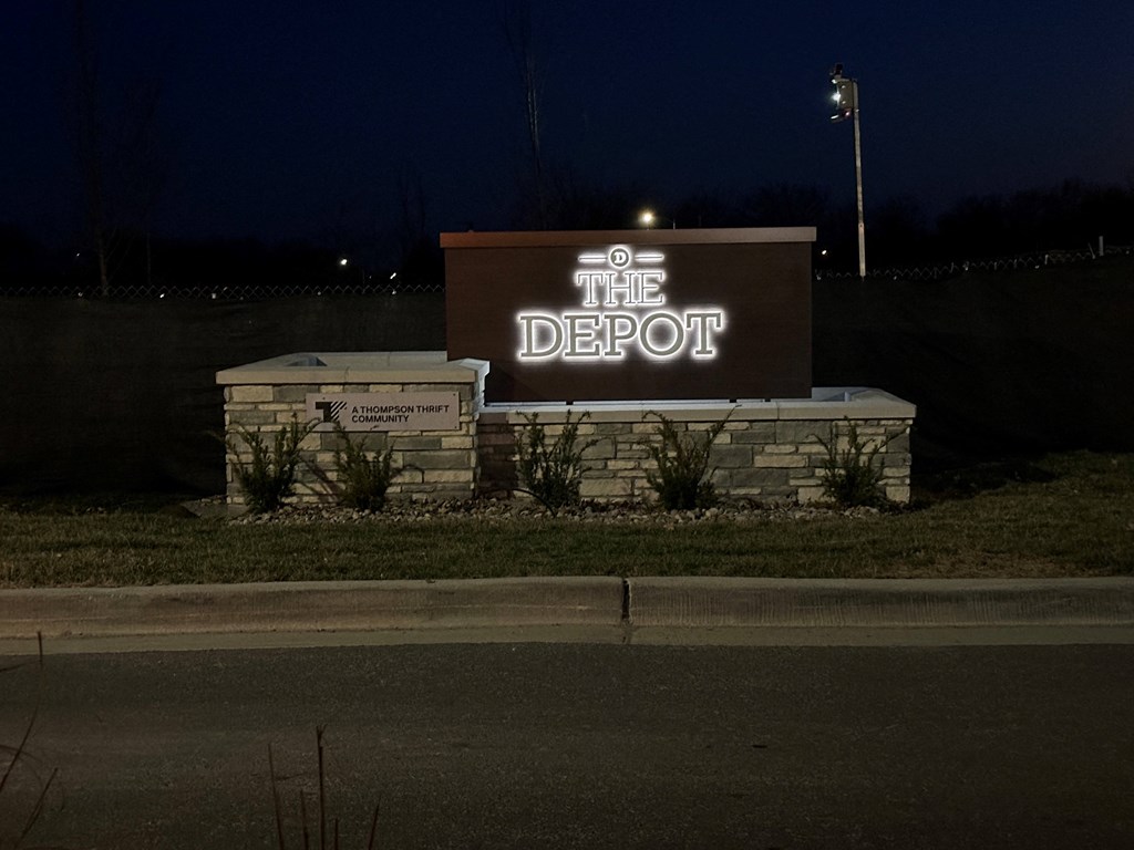 the sign for the depot at night at The Depot, Raymore, 64083
