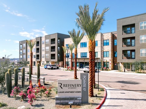 A sign in front of a building that says Refinery.