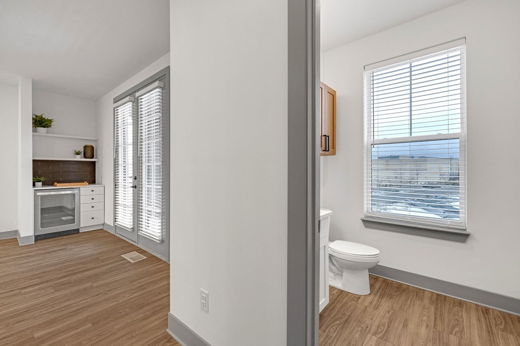 an empty bathroom with a toilet and a window at Meridian at CityPlace, Woodbury, 55125