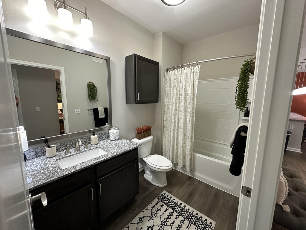 a bathroom with a shower toilet and sink and a mirror at Watermark at Steele Crossing, Fayetteville, 72703