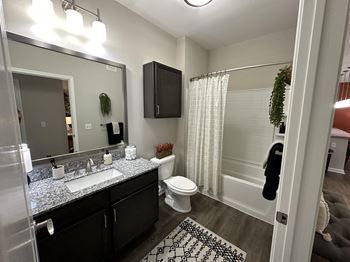 a bathroom with a shower toilet and sink and a mirror at Watermark at Steele Crossing, Fayetteville, Arkansas
