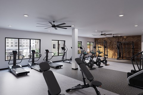 A gym with a variety of equipment including treadmills, stationary bikes, and weight machines at Refinery at Pointe17 Apartments, Phoenix, AZ