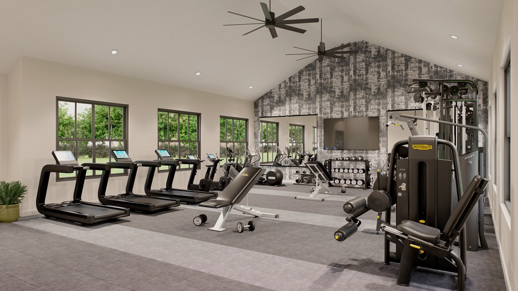 A gym with treadmills, elliptical machines, and a fan mat Switch Luxury Living in Colorado Springs, CO