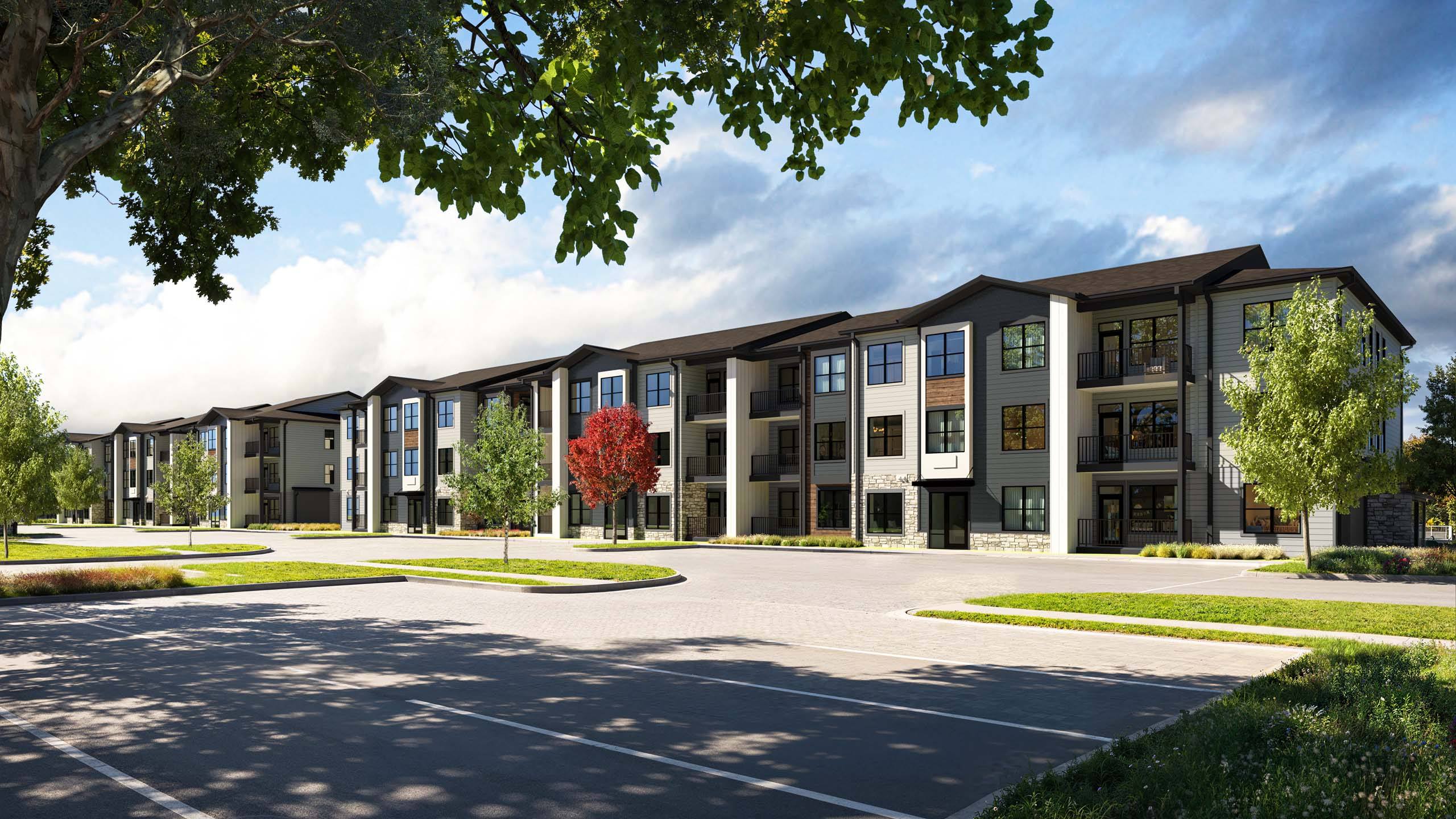 A row of modern townhouses with trees in front.