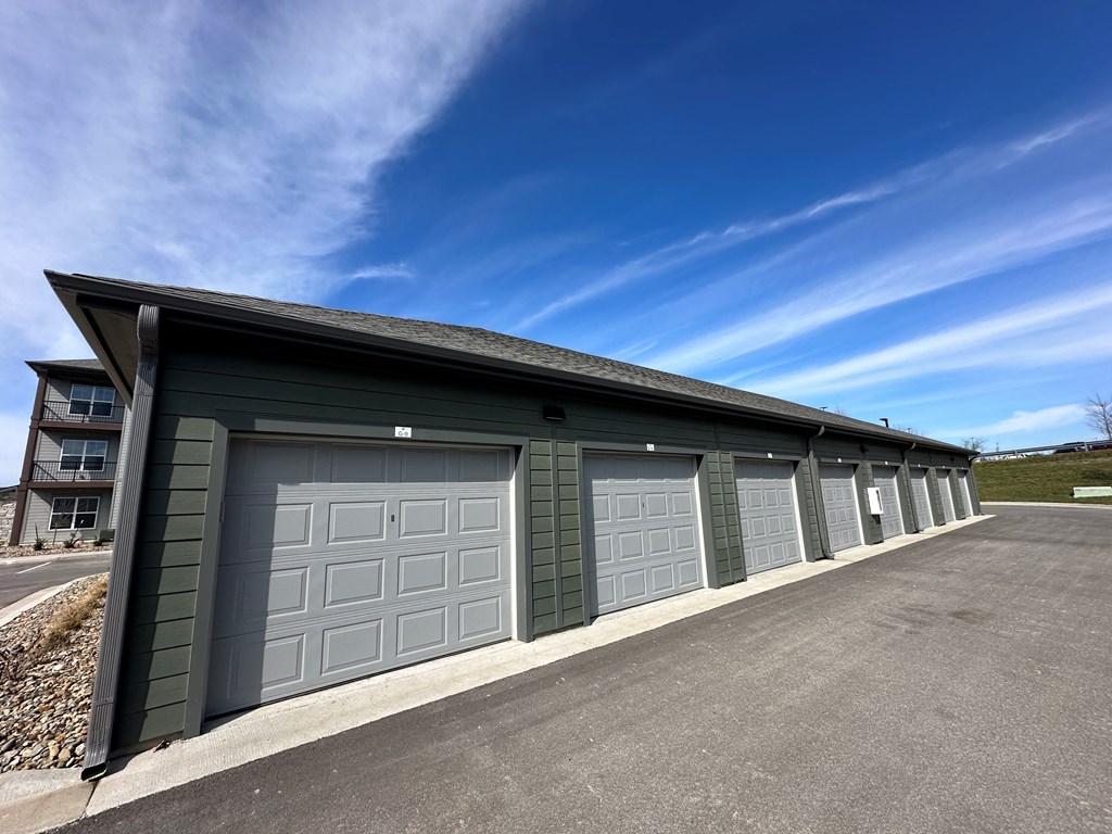 a garage with a row of garage doors and a blue sky at The Depot, Missouri