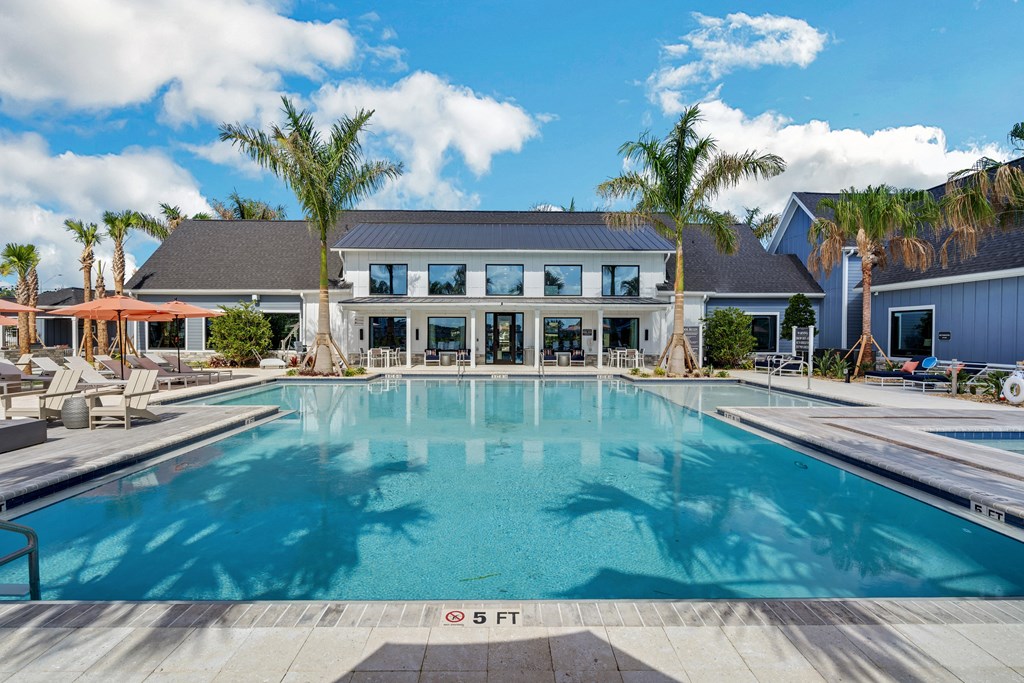 a large swimming pool in front of a building  at The Sophia, Venice, FL, 34275